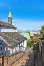 Narrow slope of cobble stairs going down along the Oura Church overlooking Nagasaki port. Royalty Free Stock Photo