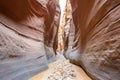 narrow slot canyon passage lined with smooth, weathered rock