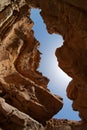 Narrow slot between two rocks in desert canyon