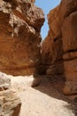 Narrow slot between two rocks in desert canyon