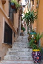 colorful painted vases and flower pots on narrow stairs in the old town of Taormina, Sicily Royalty Free Stock Photo
