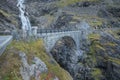 Narrow stone bridge on the serpentine of famous mountain road Troll Stigen, or Trollstigen, in Norway. Stigfossen