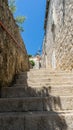 narrow stone stairs between old residential area in croatia. Adriatic coast village with stone houses and Old stone street of Royalty Free Stock Photo