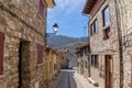 Narrow stone streets and stone houses on a sunny summer day in the medieval village.