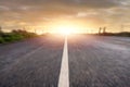 Narrow straight asphalt road with white markings at sunset. Dramatic sky. Nobody. Low angle of view. Travel concept. Motion blur Royalty Free Stock Photo