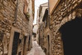 narrow street with ancient stone buildings at old european town, Peille, France Royalty Free Stock Photo