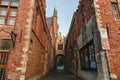 narrow street with archway and beautiful architecture in brugge, belgium Royalty Free Stock Photo