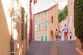 A narrow street in the beautiful French village of Roussillon, where the buildings are made with colorful. Luberon, France Royalty Free Stock Photo