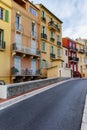 Narrow street with beautiful old houses and steps down. Bright city landscape Royalty Free Stock Photo