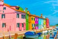 Narrow street with blue, red, green and purple house facade in the island of Burano, Venice Royalty Free Stock Photo