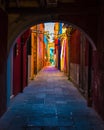 Narrow street with blue, red, green and purple house facade in the island of Burano, Venice Royalty Free Stock Photo