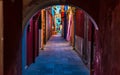 Narrow street with blue, red, green and purple house facade in the island of Burano, Venice Royalty Free Stock Photo