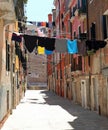 narrow street of the city with clothes hanging out to dry in the Royalty Free Stock Photo