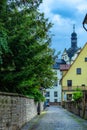 A narrow street with cobbled stones, gardens and high garden walls in Southern Germany Royalty Free Stock Photo