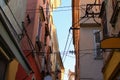 Narrow street with colorful buildings in ancient part of the city Koper. Chaos of electrical and telephone cables. Bunch of