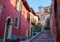 Narrow street with colorful houses along the way to the Castel San Pietro, Verona