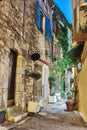 Narrow street with flowers in the old town in France. Ni Royalty Free Stock Photo