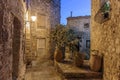 Narrow street with flowers in the old town Peille in France. Night view Royalty Free Stock Photo