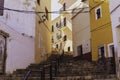 Narrow street in the form of a staircase with traditional houses with peeling plaster of the old city of Finestrat Spain