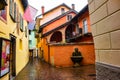 Narrow street with fountain in Ascona, Switzerland Royalty Free Stock Photo