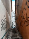 Narrow street between houses in europe. Graffiti on the wall.