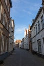 Narrow street between houses old town Brugge, Belgium Royalty Free Stock Photo