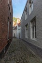 Narrow street between houses old town Brugge, Belgium Royalty Free Stock Photo