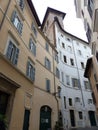 Narrow street with imposing tall ancinent buildings to Rome in Italy. Royalty Free Stock Photo