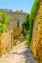 Narrow street in Lacoste village in France Royalty Free Stock Photo