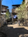 Narrow street, lane, tunnel with old houses, buildings on the sides in a poor area of the city, slums. Vertical photo Royalty Free Stock Photo