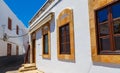 Narrow street in Lindos town on Rhodes island, Dodecanese, Greece. Beautiful scenic old ancient white houses with flowers. Famous Royalty Free Stock Photo