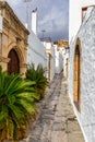 Narrow street in Lindos town on Rhodes island, Dodecanese, Greece. Beautiful scenic Lindos old ancient white houses with flowers. Royalty Free Stock Photo
