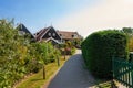 Narrow street of Marken houses, Netherlands, Europe. Green gardens and blue sky on a sunny day at sunset Royalty Free Stock Photo