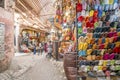 Narrow street in medina of Marrakech full of shops with souvenirs