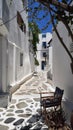 Narrow street with a chair in Mykonos, Greece Royalty Free Stock Photo