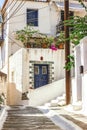 Narrow street in Neorio town on Poros island, Greece. Old white Royalty Free Stock Photo