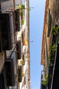 Narrow street with old historic houses with windows, balconies in Barcelona Royalty Free Stock Photo