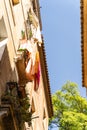 Narrow street with old historic houses with windows, balconies in Barcelona Royalty Free Stock Photo