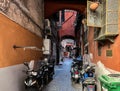 Narrow street in the old part of Naples filled with a large number of parked motorbikes, scooters and mopeds Royalty Free Stock Photo
