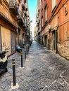 Narrow street in the old part of Naples filled with a large number of parked motorbikes, scooters and mopeds Royalty Free Stock Photo