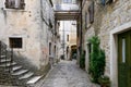 Narrow street between old residential houses of alleys in the Croatian artists' village of Groznjan Royalty Free Stock Photo