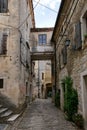 Narrow street between old residential houses of alleys in the Croatian artists' village of Groznjan Royalty Free Stock Photo