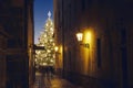 Narrow street Old Town against illuminated Christmas tree Royalty Free Stock Photo
