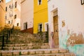 Narrow street in the old town with colored houses with shabby plaster and cobblestone stairs. Finestrat, Spain Royalty Free Stock Photo