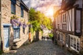 Narrow street with old traditional houses in histoical part of Dinan, Brittany Bretagne, France