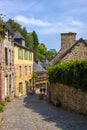 Narrow street with old traditional houses in histoical part of Dinan, Brittany, France Royalty Free Stock Photo