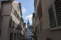 Narrow street in old Zurich. In the distance the clock tower of St. Peter\'s Church Royalty Free Stock Photo