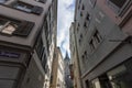 Narrow street in old Zurich. In the distance the clock tower of St. Peter\'s Church Royalty Free Stock Photo