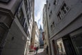 Narrow street in old Zurich. In the distance the clock tower of St. Peter\'s Church Royalty Free Stock Photo