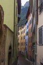 Narrow street with old architecture and alps in background Royalty Free Stock Photo